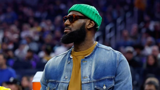 LeBron James, out with injury, attends a Lakers at Warriors game.